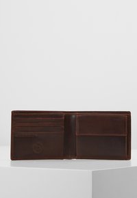 Dark brown leather wallet with six card slots and a photo pocket. Smooth texture with visible stitching and a logo detail embossed.