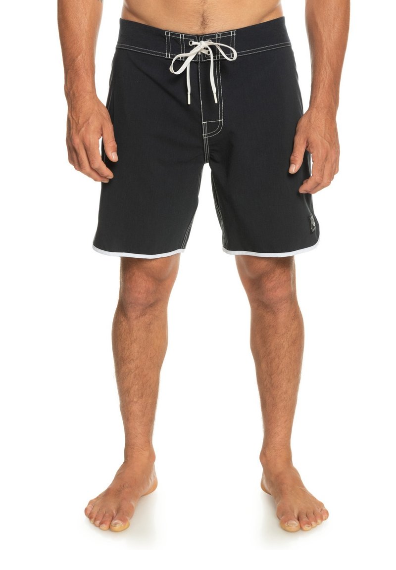 Black swim shorts with white stitching and side accents. Features a lace-up front, knee-length design, and soft fabric texture.