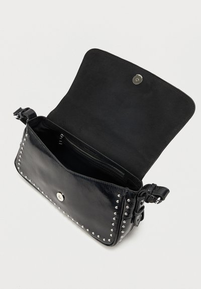 Μαύρη δερμάτινη τσάντα χιαστί με ασημένιες τρουκς, ανοιχτό καπάκι, μαγνητικό κούμπωμα, εσωτερική τσέπη με φερμουάρ και ρυθμιζόμενο λουράκι σε λευκό φόντο.