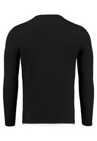 Maglietta nera a maniche lunghe con texture a costine, scollo rotondo e orlo dritto. Design semplice senza motivi o dettagli visibili.