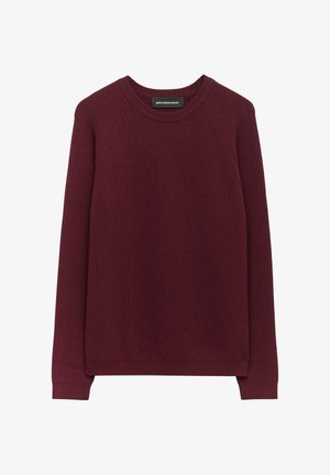 Pull en tricot bordeaux avec texture côtelée, col rond et manches raglan longues. Tissu doux avec un ourlet droit et sans boutons ni embellissements.
