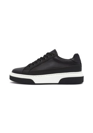 Zwarte leren sneaker met een ronde neus, platte witte tussenzool en een gestructureerde rubberen zool. Voorzien van zes veterogen en stiksels als accent.
