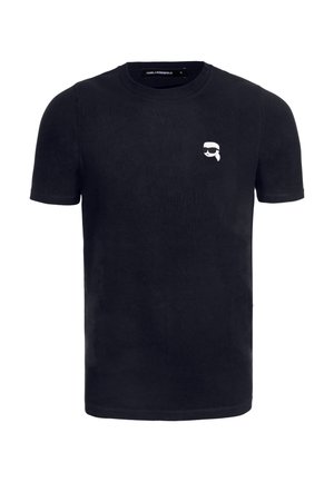 Camiseta de algodón negra de manga corta, con un gráfico de caricatura blanco en el área del pecho izquierdo. Cuello redondo clásico, textura suave.