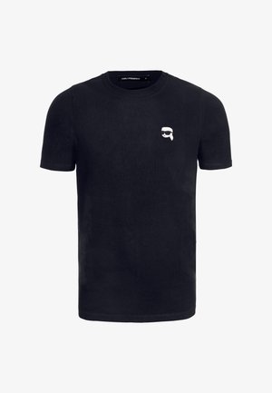 Camiseta de algodón negra de manga corta, con un gráfico de caricatura blanco en el área del pecho izquierdo. Cuello redondo clásico, textura suave.