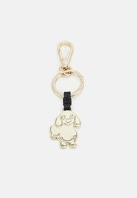 Portachiavi in metallo dorato con design di un cane cartoon, attaccato a una fascia in pelle nera, con un anello circolare per il fissaggio.