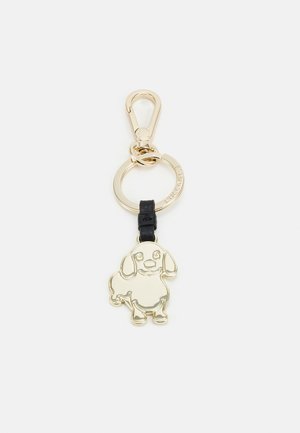 Portachiavi in metallo dorato con design di un cane cartoon, attaccato a una fascia in pelle nera, con un anello circolare per il fissaggio.