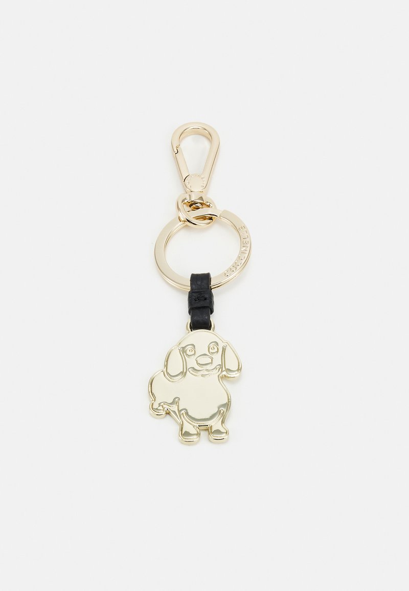 Portachiavi in metallo dorato con design di un cane cartoon, attaccato a una fascia in pelle nera, con un anello circolare per il fissaggio.