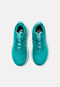 Turquoise athletic shoes with a textured mesh upper, contrasting white accents, and flat laces. Features padded collar and cushioned sole.