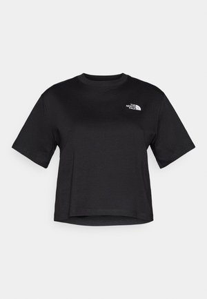 Μαύρο cropped t-shirt φτιαγμένο από μαλακό βαμβάκι. Διαθέτει κοντά μανίκια και ένα μικρό λευκό λογότυπο στην πάνω αριστερή πλευρά. Στρογγυλή λαιμόκοψη.