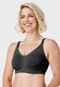 Czarny bezprzewodowy biustonosz o bezszwowym wzornictwie, teksturowanej tkaninie, regulowanych ramiączkach i dekolcie w kształcie litery V. Miękki materiał zapewnia komfort i wsparcie.