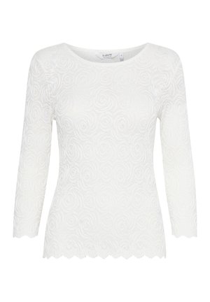 Vit långärmad topp i strukturerad tyg med ett swirlmönster, försedd med rund halsringning och vågig fåll.