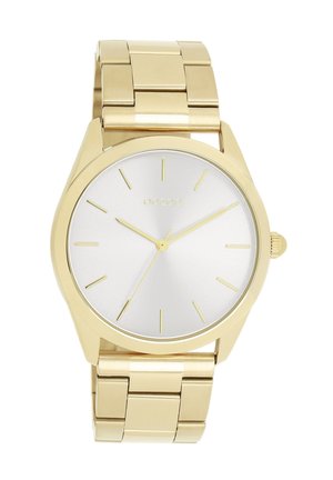 Gold metal watch with a silver face. Features a smooth, minimalist design, thin hour markers, and a polished finish on the band.