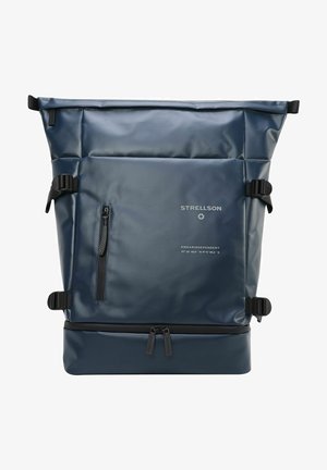 Blue roll-top backpack made of waterproof material. Features adjustable straps, a front zip pocket, and branded details on the lower section.