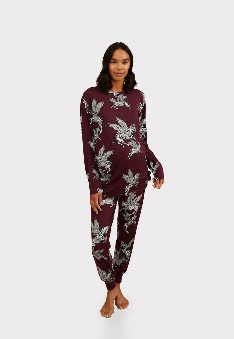 Maroon pajama set with long-sleeve top and elastic waistband pants featuring white leaf and zebra patterns; soft fabric with relaxed fit.
