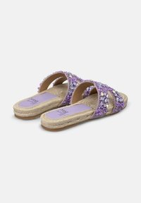 Purple slide sandals with dual straps, adorned with multicolored rhinestones, featuring a woven jute sole and cushioned footbed.