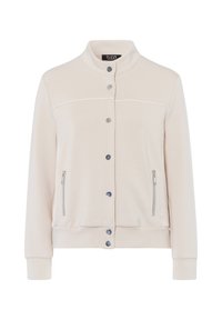Lichtbeige jasje met een staande kraag, drukknopen aan de voorkant en ritszakken aan de zijkanten. Heeft een gladde textuur en contrasterende witte stiksels.