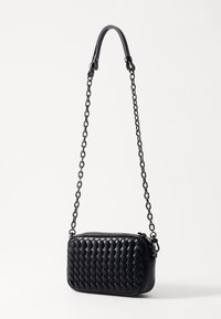 Black woven leather handbag with a rectangular shape, featuring a chain strap and zip closure. Smooth texture with a braided pattern.