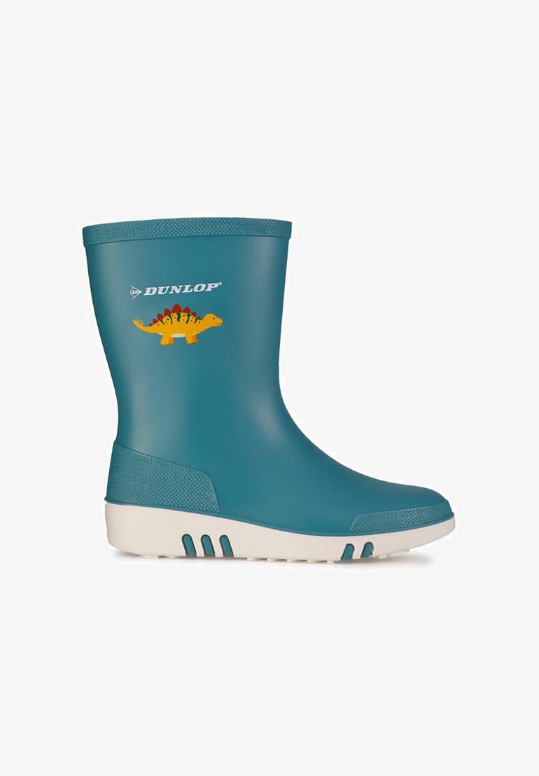 Teal rubber rain boot with a white sole, featuring a yellow dinosaur graphic and raised textured accents on the shaft and heel for grip.