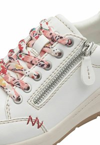 White leather sneaker with floral-patterned laces, a side zipper, and red stitching detail. Features metal eyelets and a textured sole.