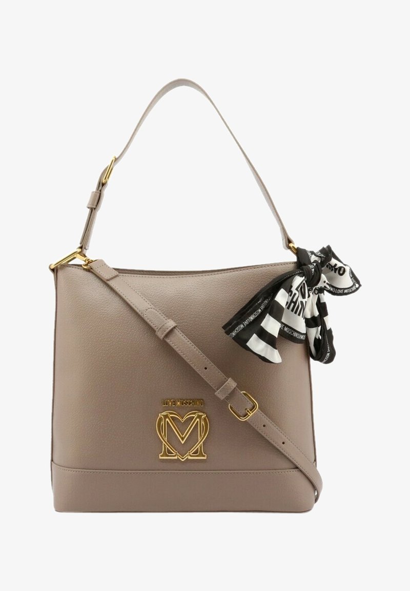 Beige leather handbag with a structured shape, featuring a gold logo and a black and white striped scarf tied at the handle.