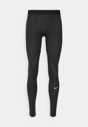 Schwarze Sportleggings mit glatter Textur, die eine enge Passform und subtile Nahtdetails aufweisen. Mit kleinem Logo am unteren Bein.