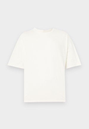White cotton t-shirt with short sleeves, round neck, and a relaxed fit. Smooth texture with no visible patterns or hardware details.