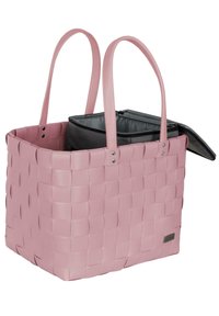 Woven pink plastic tote with dual handles and a removable black inner pouch featuring a zipper and flap opening. Silver hardware accents.