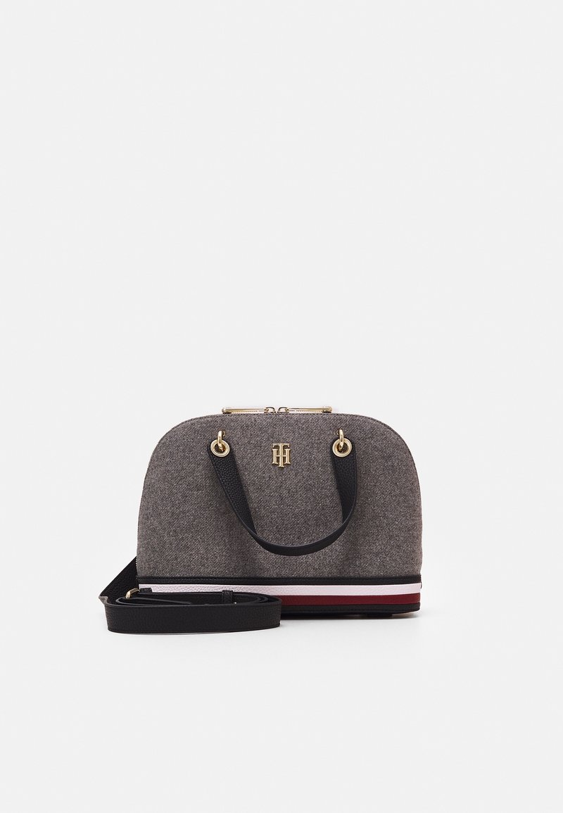 Grey felt handbag with gold hardware, rounded shape, dual top handles, and a removable black strap. Features a striped accent along the base.