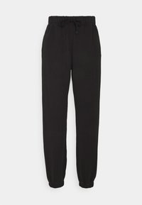 Svarta, mjuka joggers i tyg med elastisk midja, dragsko och elastiska muddar. Sidofickor och en avslappnad passform.