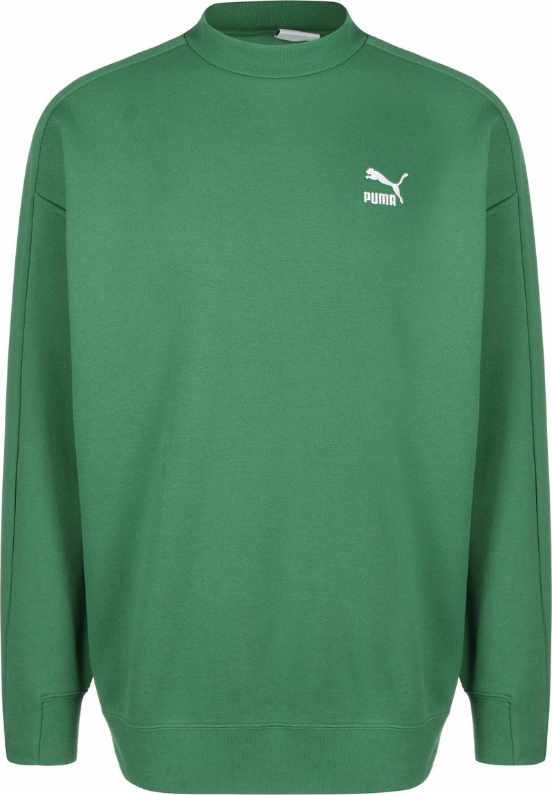 Zaļa sporta krekls, izgatavots no mīkstas, teksturētas auduma. Tam ir augsts kakls, garas piedurknes un baltā Puma logo uz kreisā krūts.