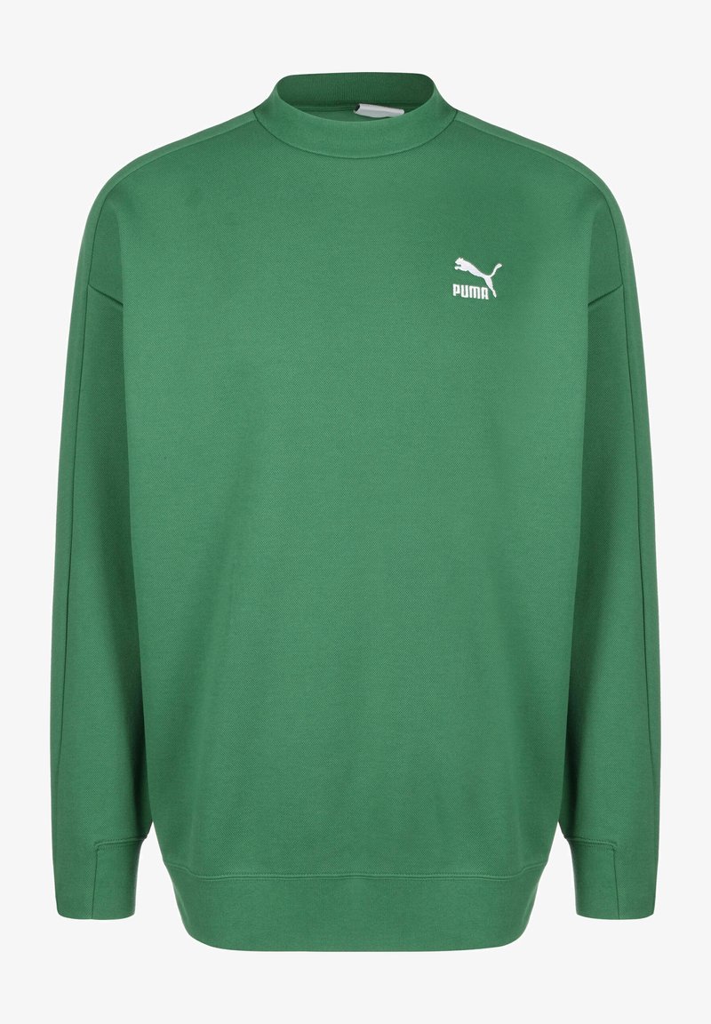 Zaļa sporta krekls, izgatavots no mīkstas, teksturētas auduma. Tam ir augsts kakls, garas piedurknes un baltā Puma logo uz kreisā krūts.