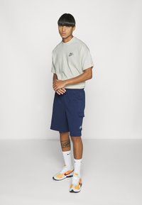 Nike Sportswear CLUB CARGO - Calças de fato de treino - blau