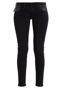 Jeans de denim negro ajustados con cintura de media altura, que cuentan con un bolsillo con cremallera y un ligero desgasto. Textura suave y diseño ceñido.