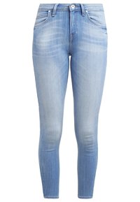 Jeans ajustados en denim azul claro, con un diseño clásico de cinco bolsillos, un ligero desgaste y una cremallera con cierre de botón.