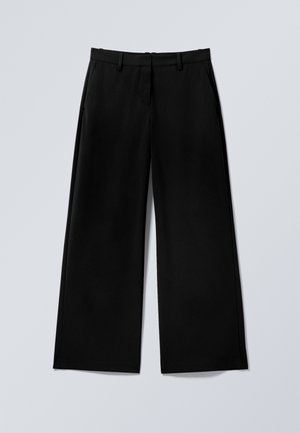 Pantalon noir à jambes larges avec passants pour ceinture, fermeture éclair frontale et poches latérales, posé à plat sur une surface gris clair.