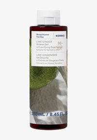 Brązowa plastikowa butelka zawierająca żel pod prysznic o zapachu limonki i imbiru. Etykieta zawiera biały tekst z informacjami o produkcie. Zawiera obrazek limonki i szałwii.