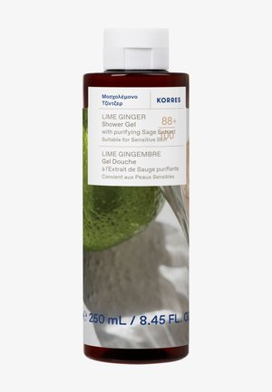 Ruskeasta muovipullosta, joka sisältää limetti-inkiväärisuihkugeeliä. Etiketissä on valkoista tekstiä tuotetiedoista. Sisältää kuvan limestä ja salvista.