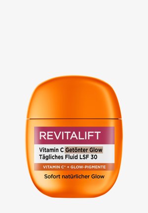 Flacon orange de Revitalift Vitamine C fluide teinté quotidien avec SPF 30, mettant en avant des pigments éclatants et un effet éclat naturel.