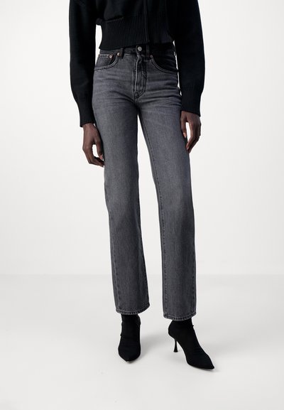 Black high-waisted jeans with a straight leg design, made from denim. Features a zip fly, five pockets, and a faded gray finish.