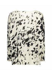 Maglione lavorato a maglia bianco e nero con vestibilità ampia, scollatura larga e bordo a coste. Presenta un design astratto macchiato su tutta la superficie.