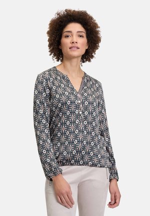 Langärmelige, gemusterte Bluse in Dunkelblau und Creme, mit V-Ausschnitt, elastischen Bündchen und floralen Motiven auf leichtem Stoff.