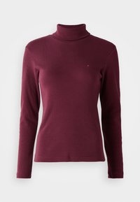 Maglione a collo alto bordeaux con maniche lunghe, realizzato in tessuto a coste, caratterizzato da un design aderente e un piccolo logo ricamato sul davanti.