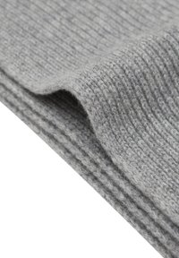 Grijze gebreide stof met een geribbelde textuur, met een soepele plooi en zachte, pluizige vezels. Lichtgewicht en flexibel van ontwerp.