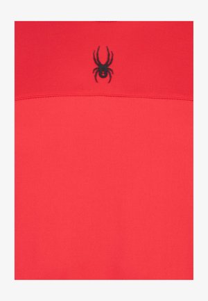 Rød kortærmet beklædningsgenstand lavet af glat stof, med et sort edderkoppe-logo på brystet og en simpel horisontal sømdetalje.