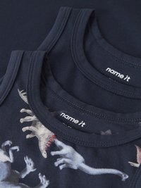 Dve temno modri brezrokavniki za otroke, ena enobarvna in ena z belimi in bež odtisi dinozavrov na sprednji strani.