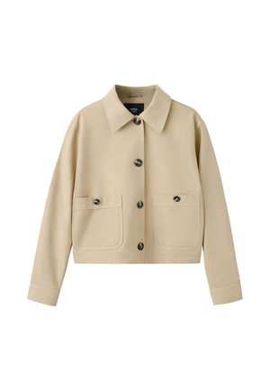 Veste beige courte avec manches longues, col pointu, fermeture boutonnée devant et deux poches avant avec rabats à boutons.