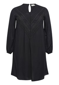 Vestido negro con mangas largas abullonadas, un escote con apertura en forma de llave y detalles texturizados en chevron. Material suave con un corte relajado.