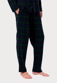 Πιτζάμες σε σκαρίφημα σε σκούρο πράσινο και ναυτικό, φτιαγμένες από μαλακό ύφασμα. Σχέδιο ίσιας γραμμής με δύο πλαϊνές τσέπες και ελαστική μέση.