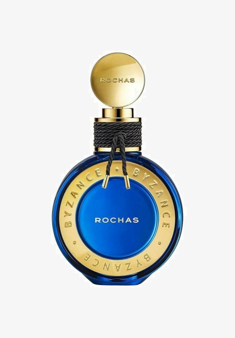 Blå glas parfume flaske med cirkulær form, gylden låg og gyldne detaljer med "ROCHAS BYZANCE" indskrevet rundt om bunden.