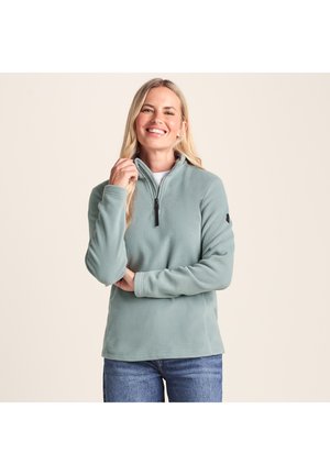 Light green fleece pullover with a quarter-zip neck, long sleeves, and a soft texture. Features a logo accent on the sleeve.
